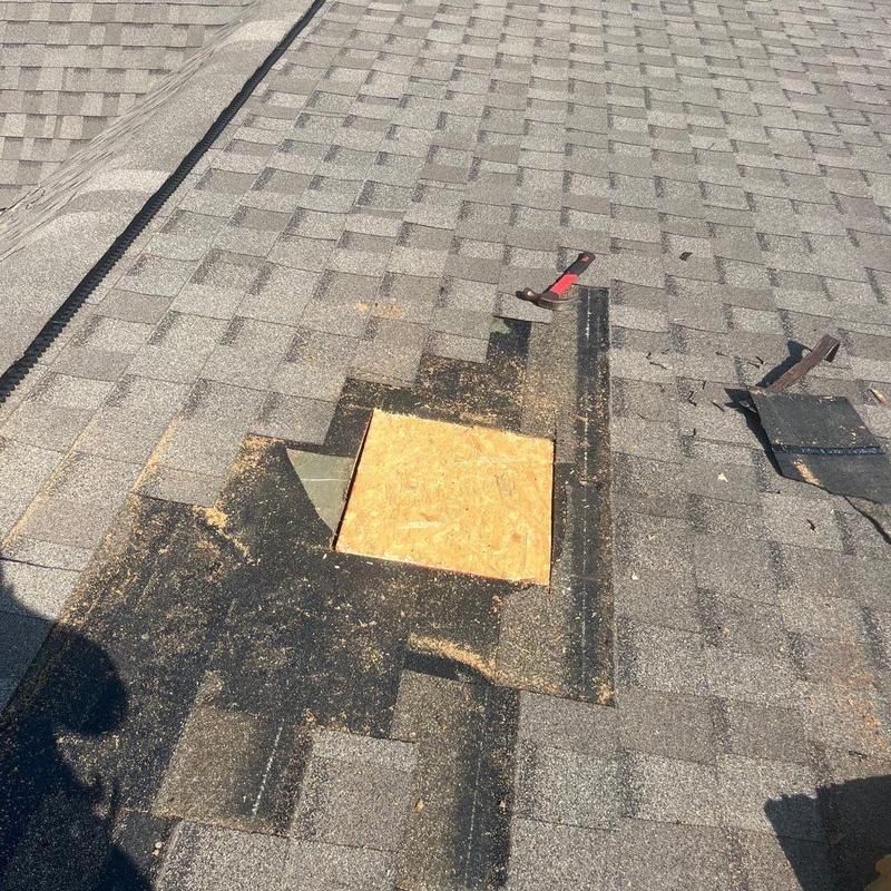 Roof shingle area with plywood patch and removed shingles