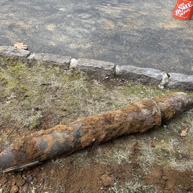 Old corroded sewer pipe removed outdoors Old corroded sewer pipe removed outdoors