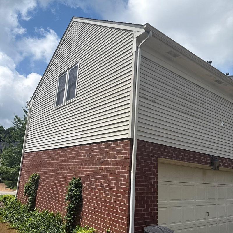 Vinyl siding exterior showing weathering and dirt marks