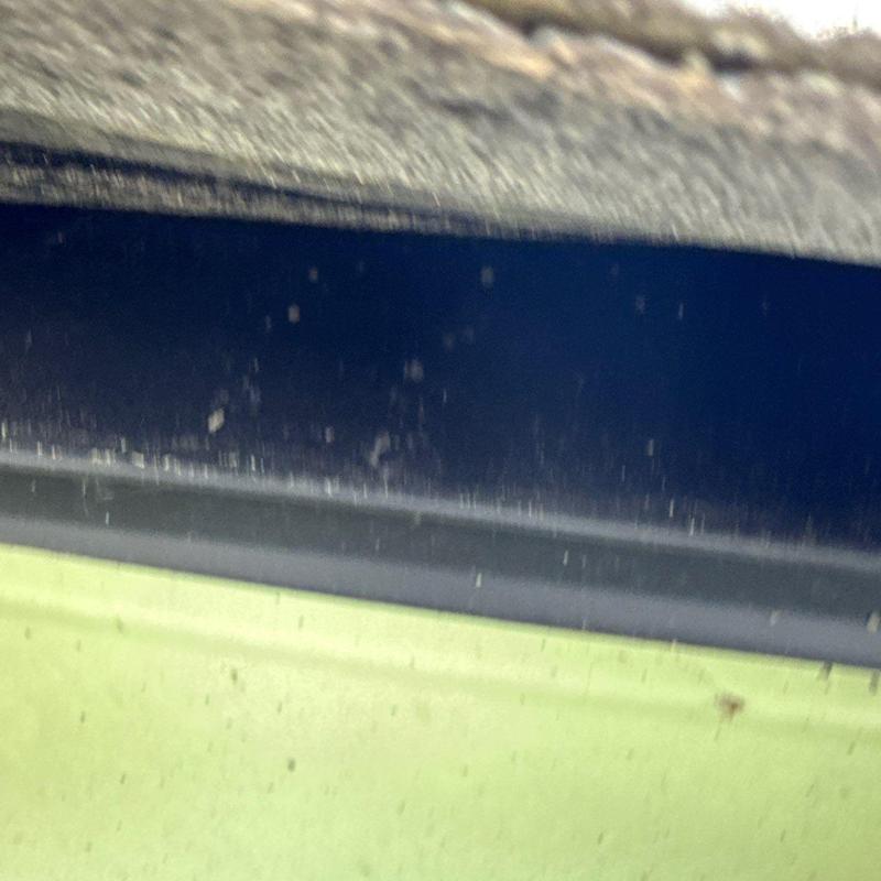 Roof edge flashing with granule loss and wear signs