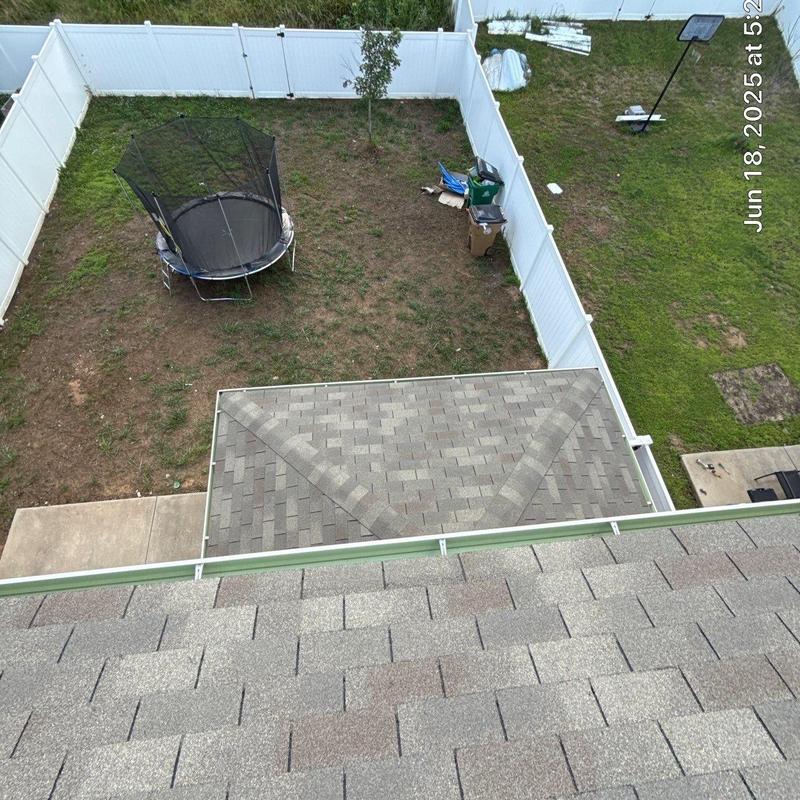 Asphalt shingle roof with gutter and backyard view