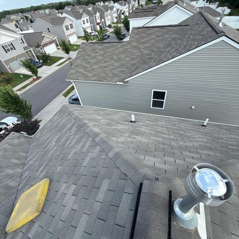 Asphalt shingle roof with vent pipe and flashing inspection