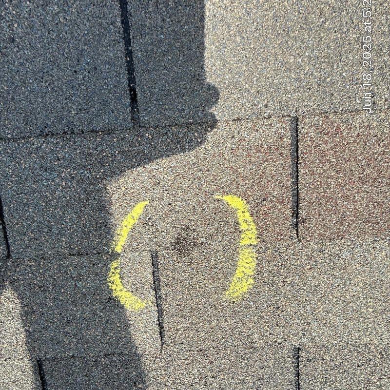 Asphalt shingle roof with hail damage marked in yellow