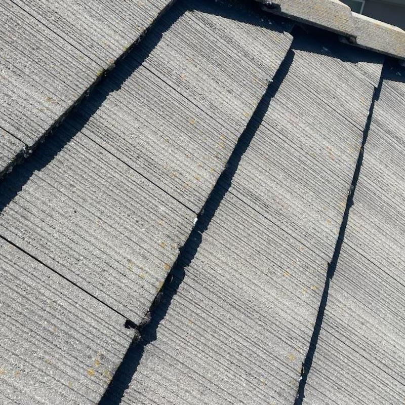 Concrete roof tiles with replaced broken tiles