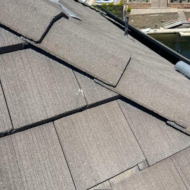 Concrete roof tiles with broken tile replaced