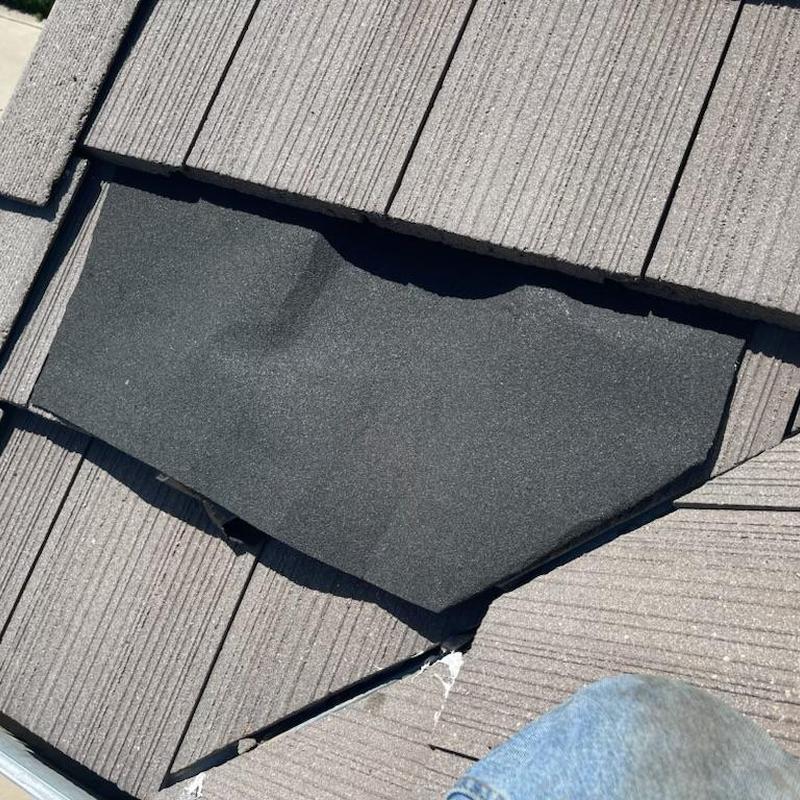 Roof tile underlayment patch on gray tile roof