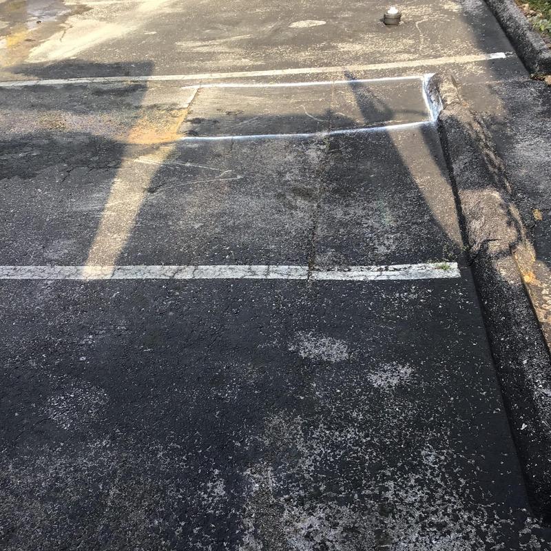 Asphalt parking lot marked for cutting and repair