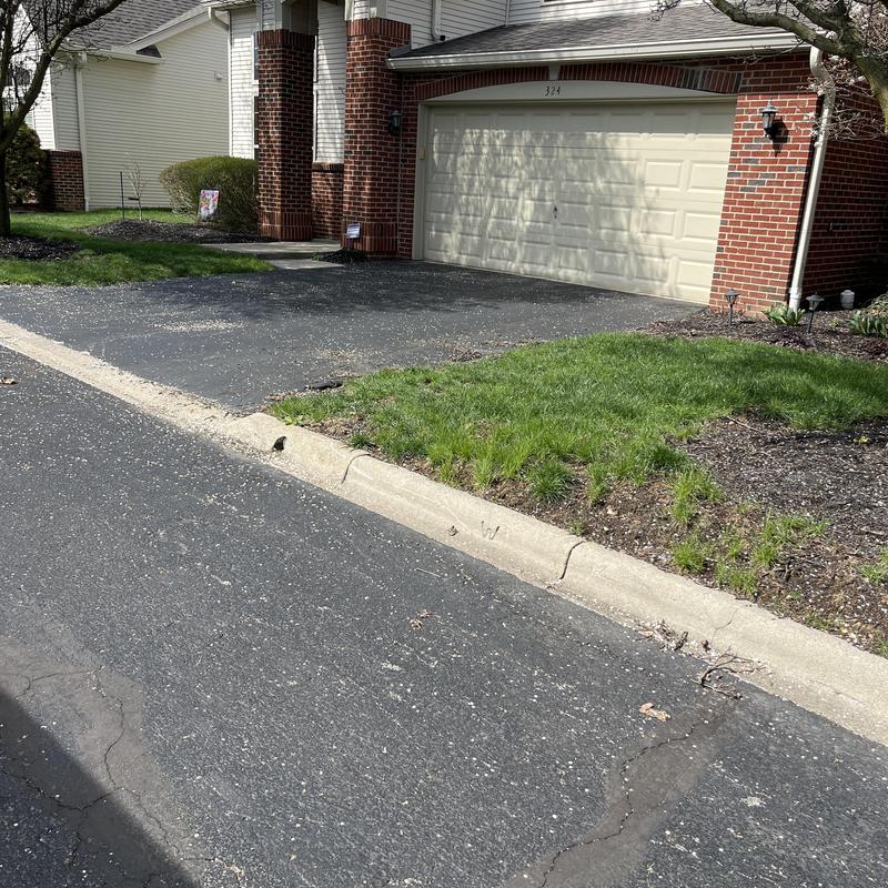 Driveway asphalt with curb and garage entrance Driveway asphalt with curb and garage entrance
