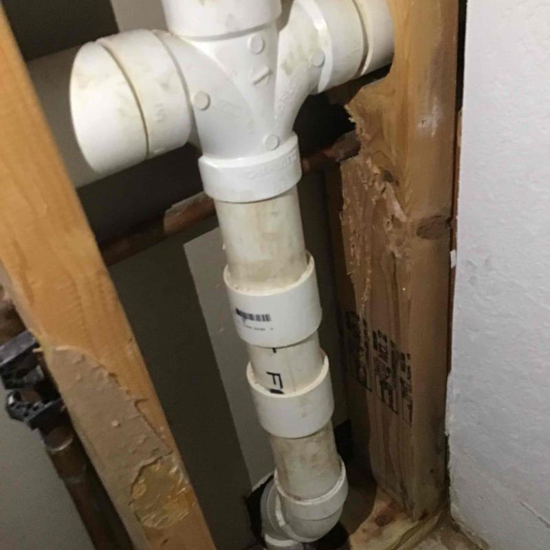 PVC drainage pipe installed in wall cavity