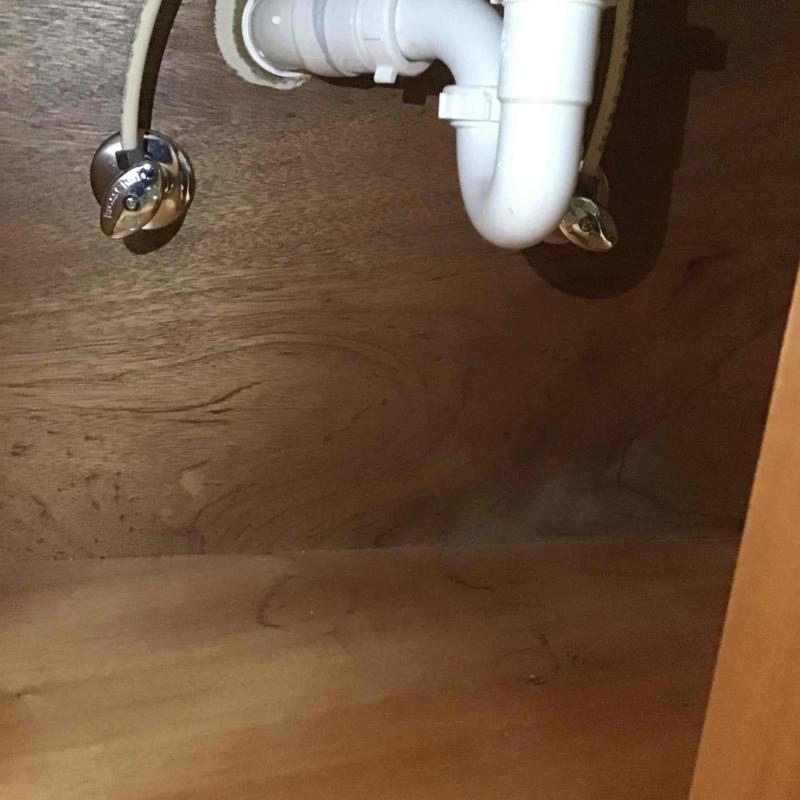 Sink drain pipe and water supply valves under cabinet