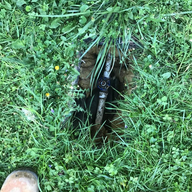 Outside ball valve in grassy yard exposed for replacement