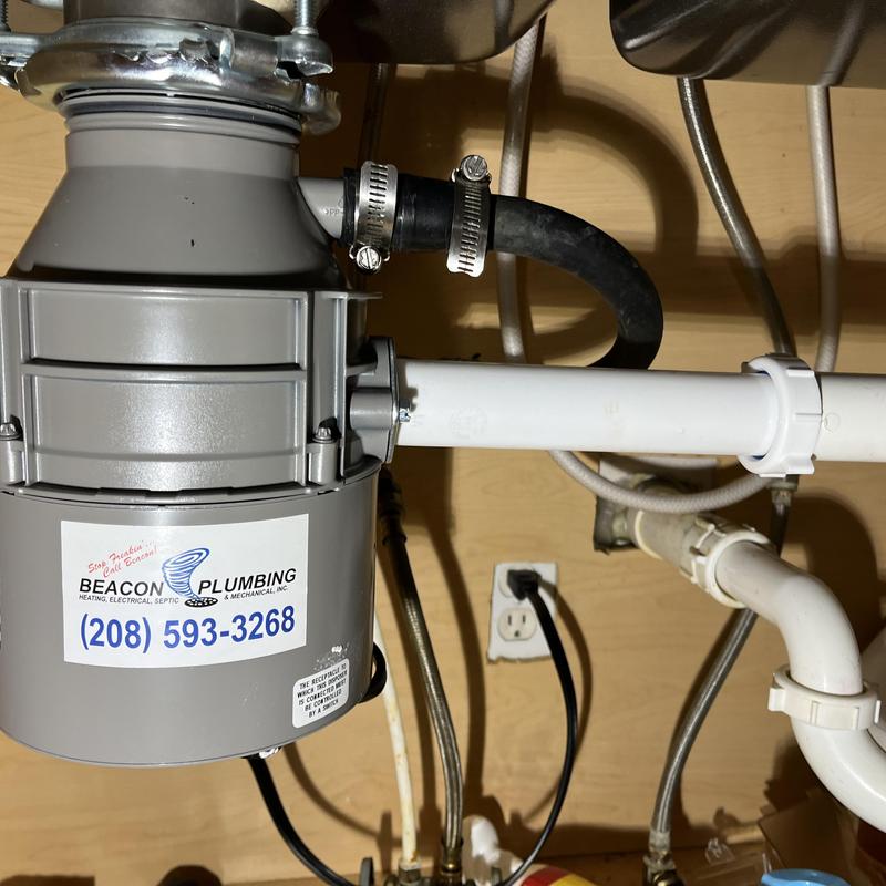 Garbage disposal unit with plumbing connections installed