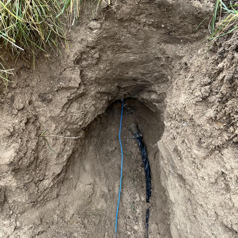 Main water service line exposed in yard trench Main water service line exposed in yard trench