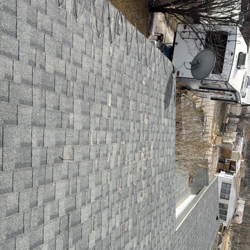 Asphalt shingle roof with minor wear and debris