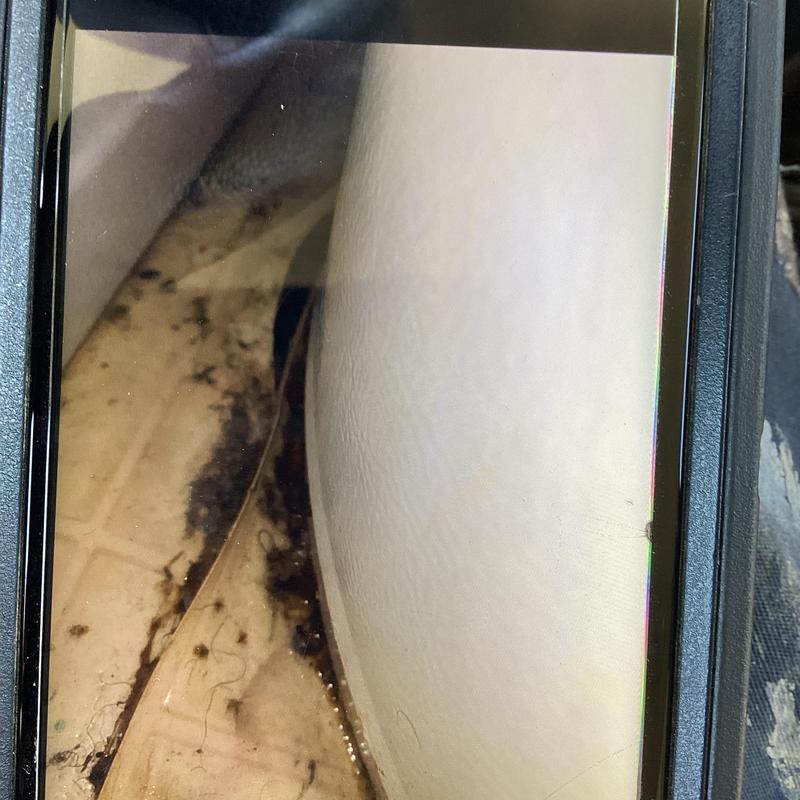 Water heater leaking at base with water on floor