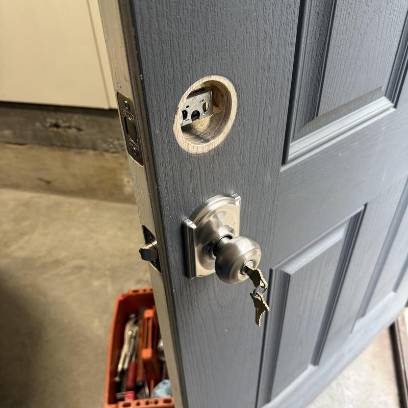 Door knob with key and empty deadbolt hole