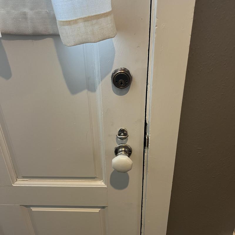 Deadbolt and doorknob lock on white interior door