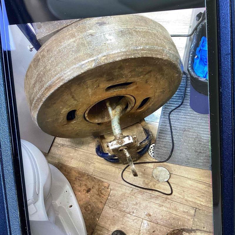 Mainline drain cleaning snake near commode access