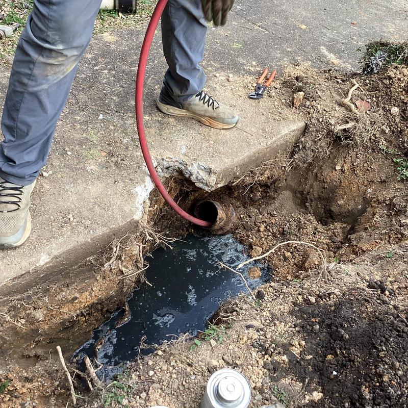 Sewer line cleaning with backhoe excavation and jetting