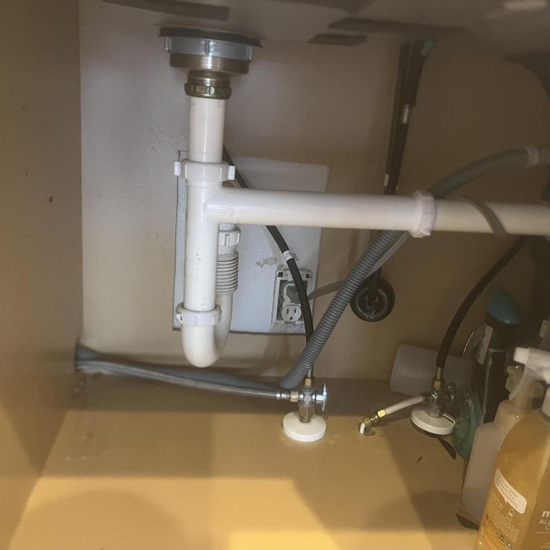 Kitchen sink PVC drain pipes under cabinet with water supply lines Kitchen sink PVC drain pipes under cabinet with water supply lines