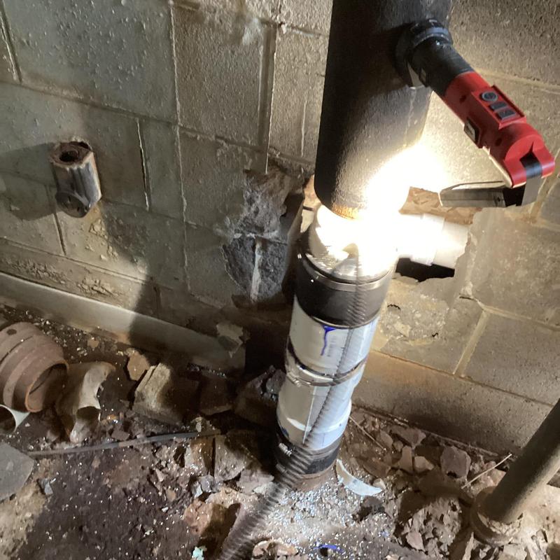 Main sewer line with cable clearing blockage in basement