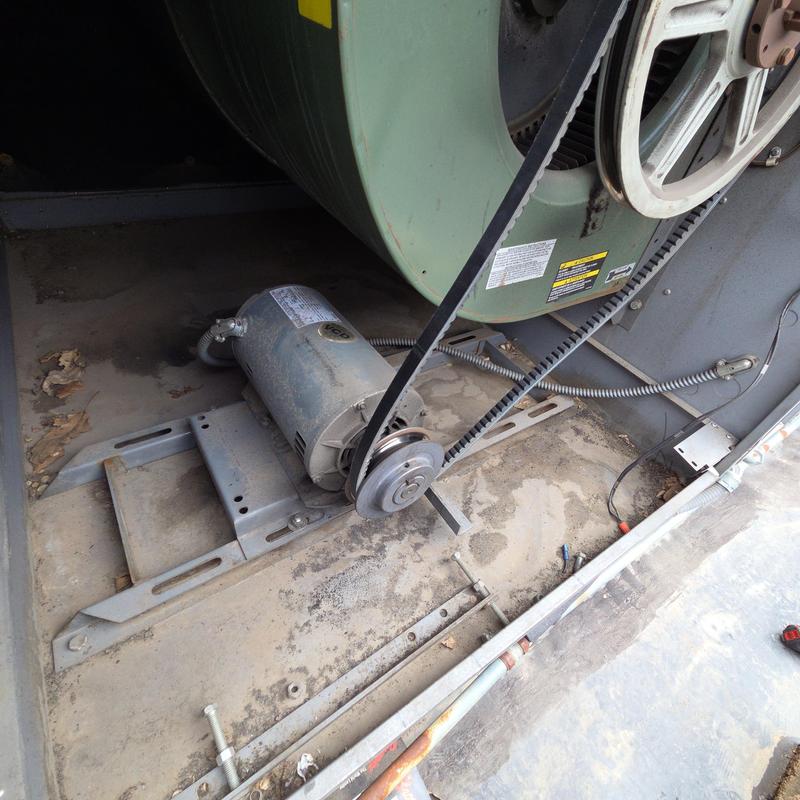 HVAC blower motor and belt drive system in unit