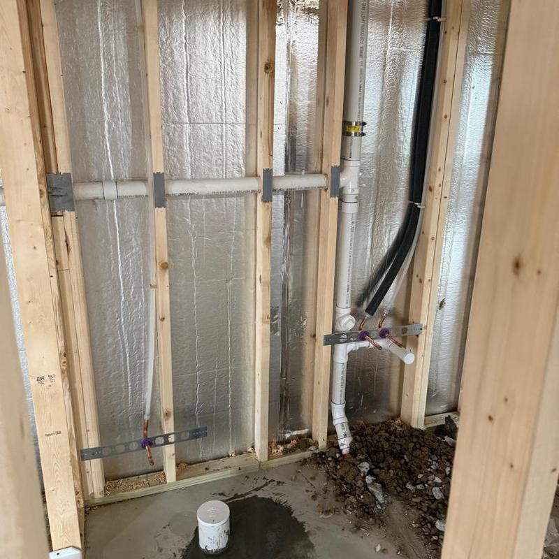 Basement bathroom plumbing rough-in with PVC pipes