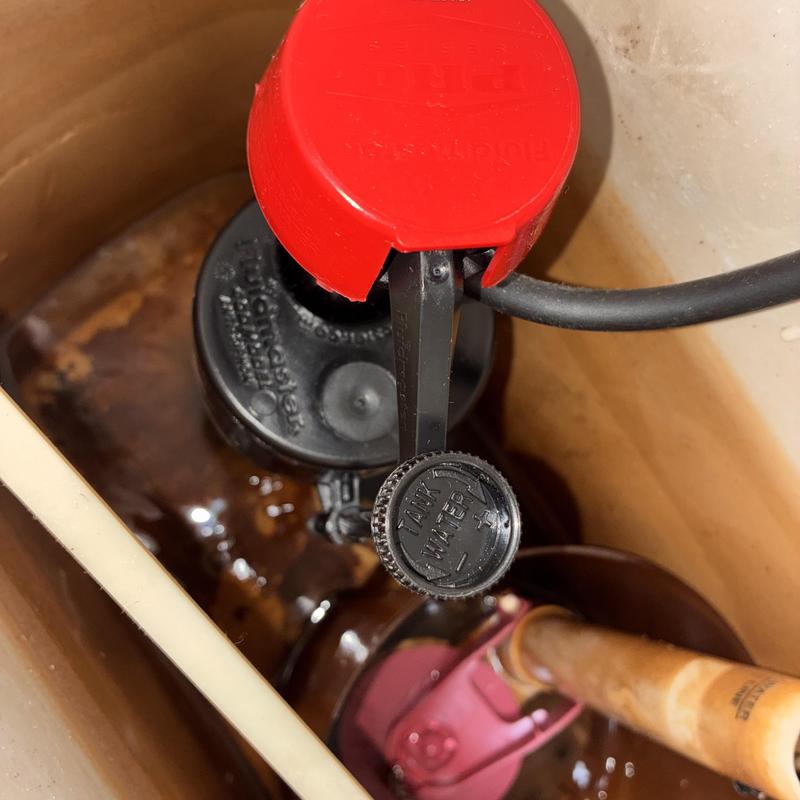 Toilet fill valve and flapper inside tank