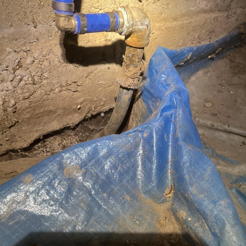 Under-sink drain piping with clamp in crawl space