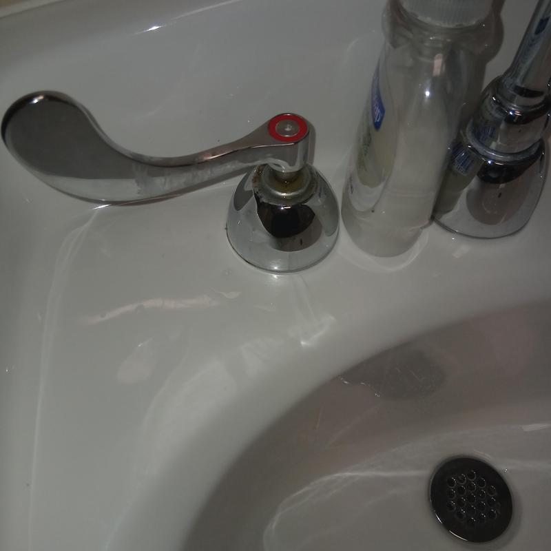Bathroom sink faucet handle with soap dispenser nearby Bathroom sink faucet handle with soap dispenser nearby