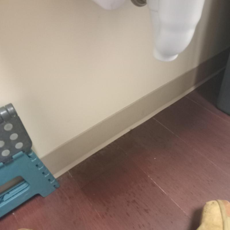 Main line plumbing pipe under wall with floor tiles Main line plumbing pipe under wall with floor tiles