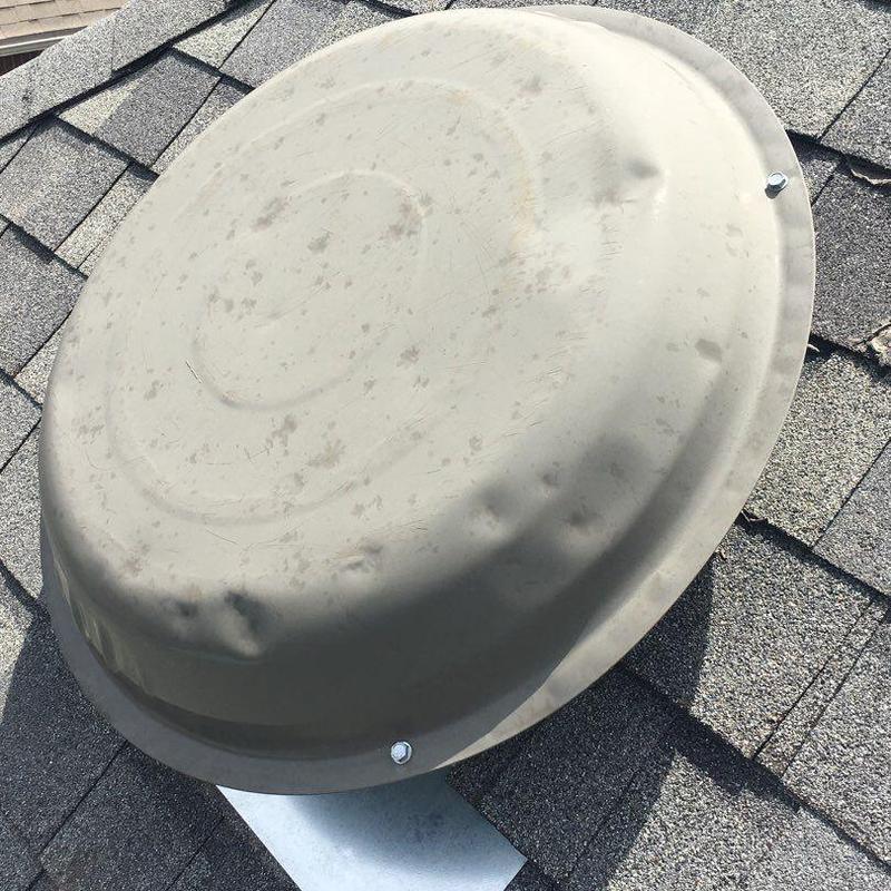 Roof vent cover with hail damage on shingles Roof vent cover with hail damage on shingles