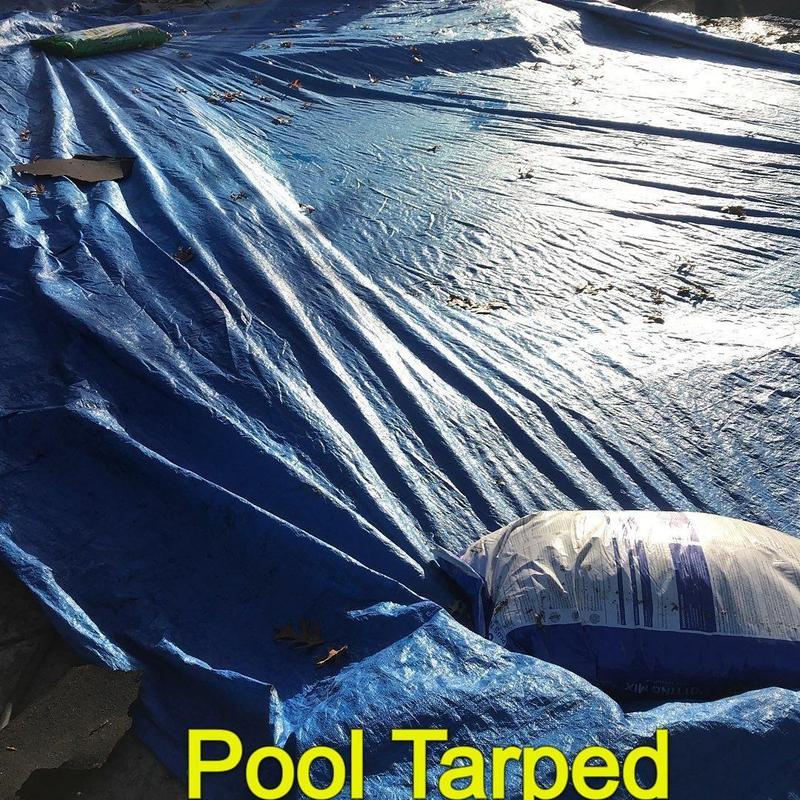 Pool covered with blue tarp secured by sandbag Pool covered with blue tarp secured by sandbag