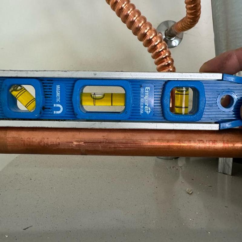 Copper T&P pipe leveling with blue level tool