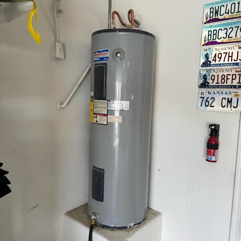 Electric water heater installation with pan and fittings