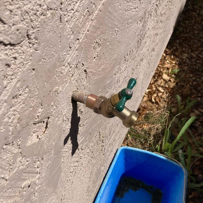 Hose bib installation on exterior wall with valve handle