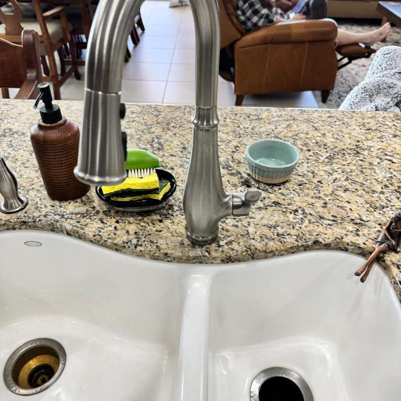 Kitchen faucet on granite countertop with sink