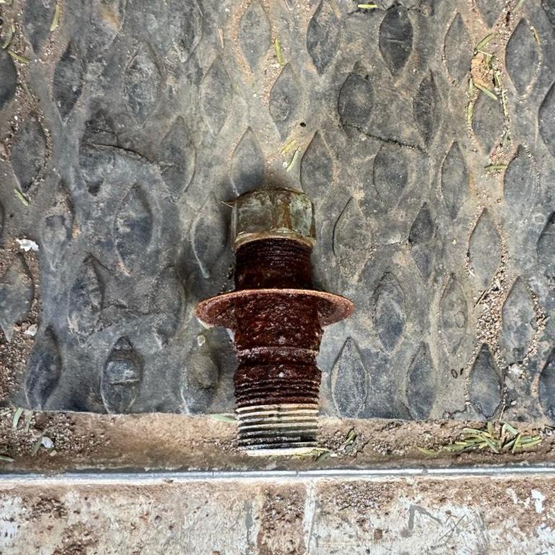 Rusty water heater nipple removed on diamond plate floor