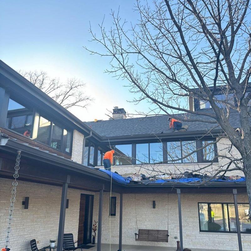 Asphalt shingle roof with hail damage workers