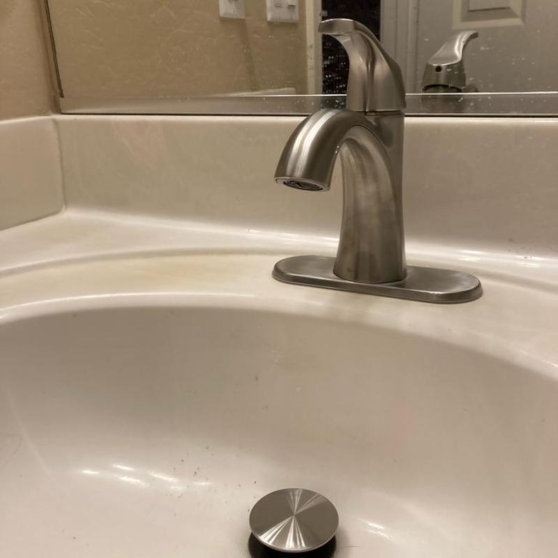 Bathroom sink faucet and countertop with drain stopper