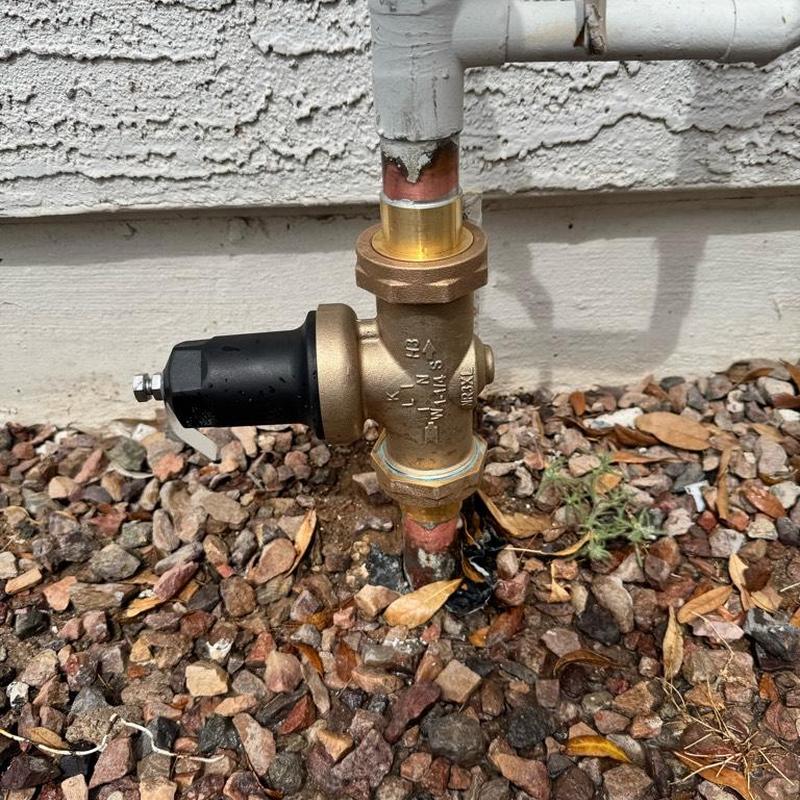 Pressure reducing valve on main copper riser outdoors