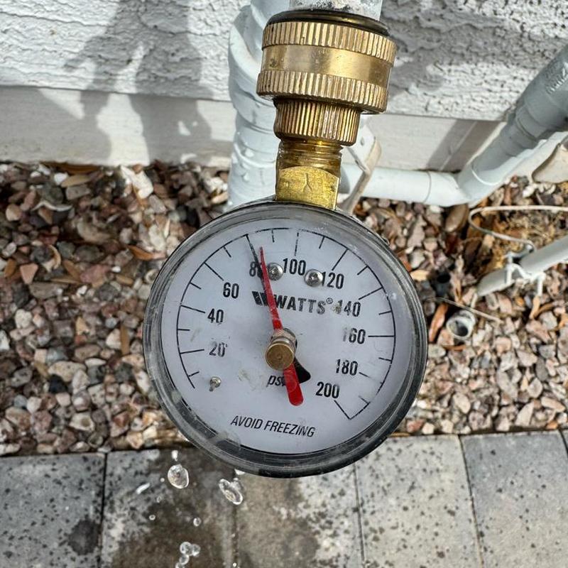 Pressure gauge on outdoor hose bib measuring water pressure