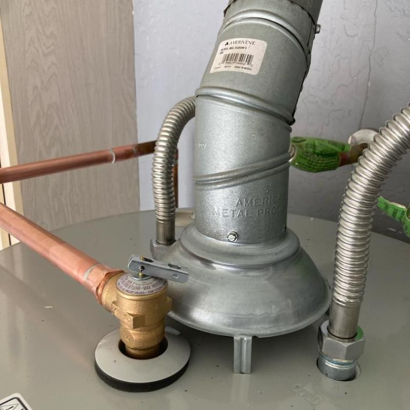 Gas water heater vent and pressure relief valve close-up