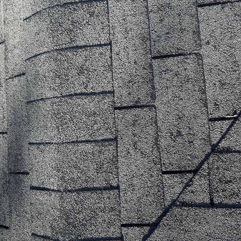 Asphalt roof shingles close-up with hail damage marks