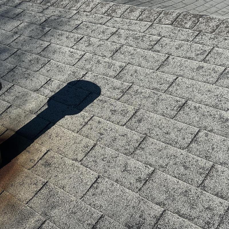 Asphalt shingle roof with hail damage and inspection shadow