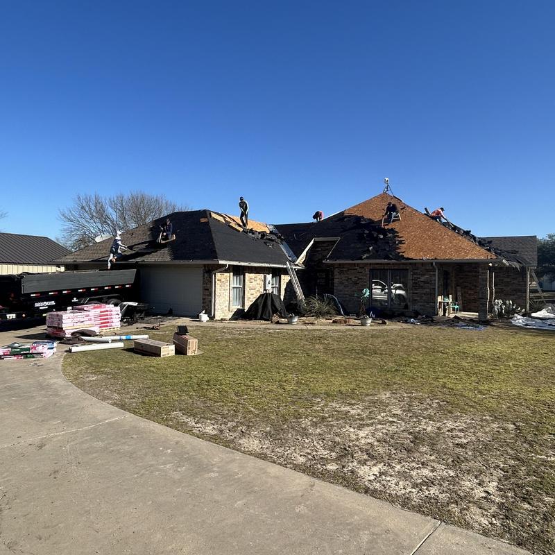 Residential roof removal and decking inspection in progress