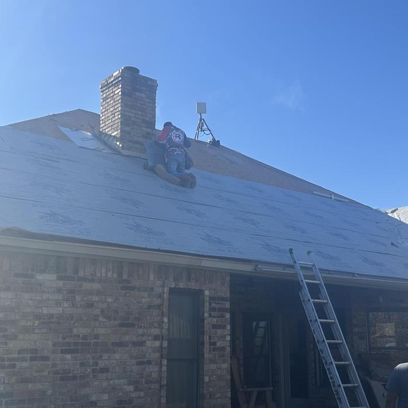 Synthetic underlayment installation on residential roof