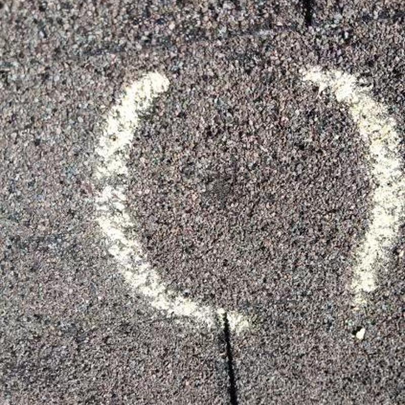 Asphalt shingle roof hail damage marked for inspection