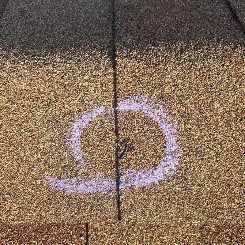Asphalt shingle roof with marked crack and damage