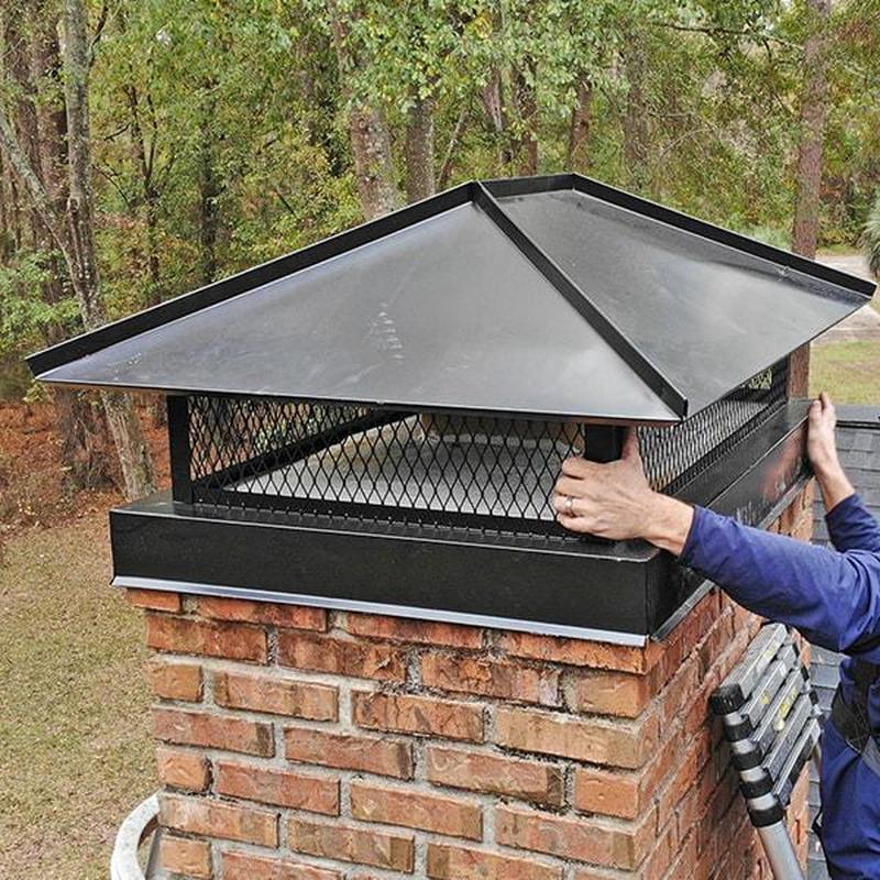 Chimney cap installation on brick chimney outdoors